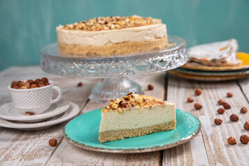 Cheese cake with hazelnuts on wood background
