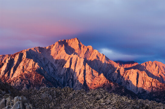 Good morning Mount Whitney landscape, with some heavy clouds moving out. This scenic image is of the largest peak in the lower 48 US states.  rich with sunrise color and texture of mountains ranges.