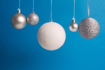 hanging christmas balls on blue backdrop 