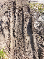 Traces of off-road tires. Cracked earth on country road with traces of tires, cars, cracks and...