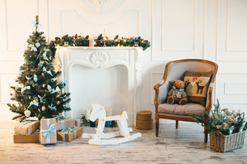 Interior of child's room for Christmas, with decorated Christmas tree, fireplace and candles.