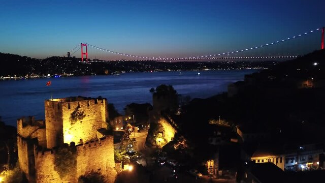 Anatolian Castle, Anadolu Hisari Fortress and FSM Bridge at night. Kucuksu region in Istanbul. Aerial
