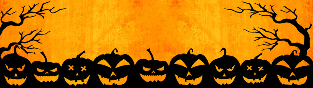 HALLOWEEN background banner wide panoramic panorama template -Silhouette of scary carved luminous cartoon pumpkins and tress isolated on abstract grunge orange texture