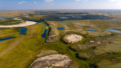 Naklejka premium Landscape of the forest-tundra and the sandy river bank, bird's eye view.Arctic Circle, tunda. Beautiful landscape of tundra from a helicopter.
