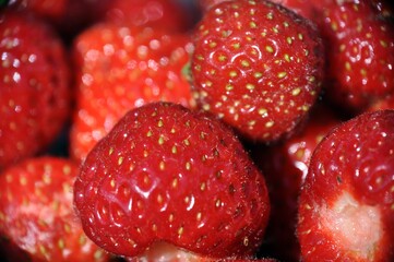 closeup macro close up red berry strawberry with seeds at sunny day