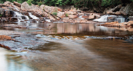 Stunning waterfalls  in the middle of forest and flowing through rocky surfaces