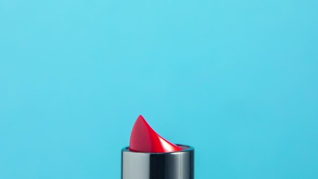 Close up video of red lipstick rising 