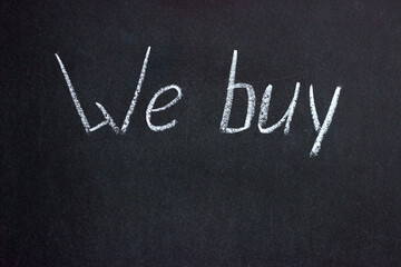 
The inscription on the chalkboard "We buy". A common phrase in business and finance