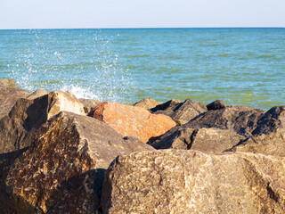 Seascape, background granite and the sea in haze. Waves breaking on huge granite stones