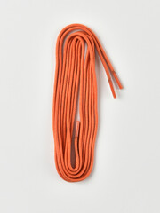 Obraz na płótnie Canvas Orange shoe laces on a white background.