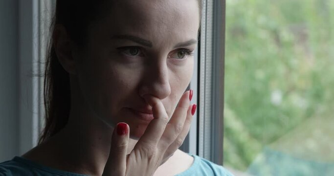 Woman Picking Nose with Red Nails Standing by the Window