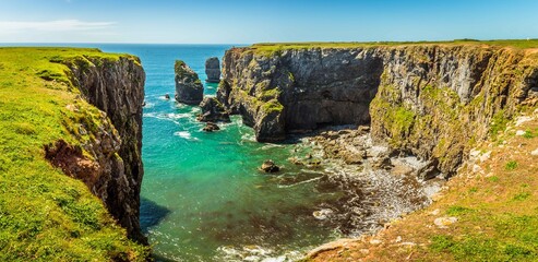 A circular bay with offshore stacks on the Pembrokeshire coast, Wales near Castlemartin in early summer © Nicola