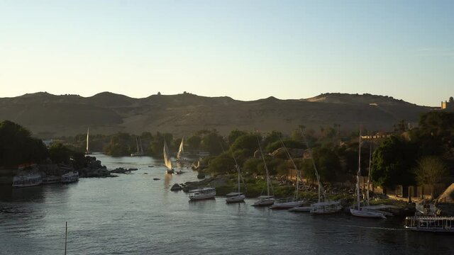 Beautiful sunset Aswan Nile river with felluca sail scene skyline