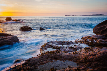 Colourful sunset at the Cote de Granit Rose at the coast of Brittnay, France