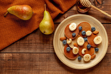 Autumn wood background with pancakes
