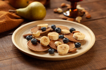 Pancakes with fruits, closeup.