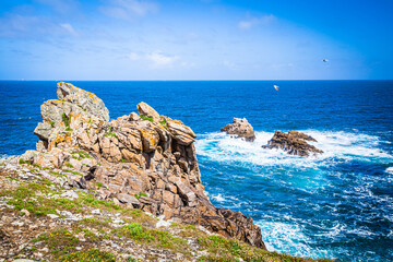 Rocks, stormy waves and lighthouses at the Pointe du Raz in Brittany, France