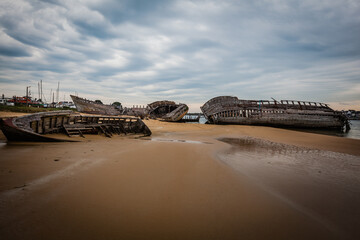 Old shipwrecks at the ship cemetary at river Etel in Brittany, France