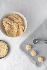Coconut macaroons scooped onto a baking sheet