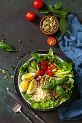 Healthy food. Tuna salad with egg, lettuce, quinoa, vegetables and pumpkin seeds. Top view flat lay background. Copy space.