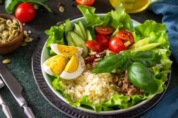Healthy food. Tuna salad with egg, lettuce, quinoa, vegetables and pumpkin seeds.