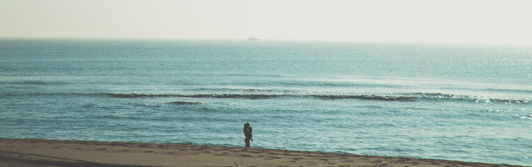 Fototapeta na wymiar woman with baby in south beach alone enjoying the beach 
