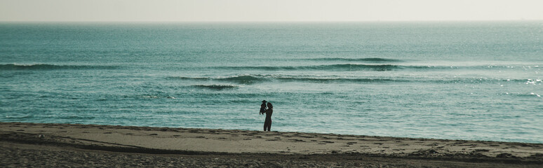 woman with baby in south beach alone enjoying the beach 
