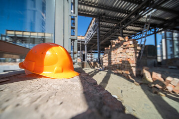Helmet left on the construction of a large hotel. Bright and sunny unfinished interior - 374378308