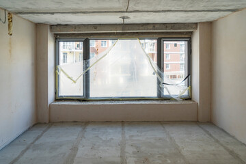 Empty unfinished interior with natural light. Hotel apartment construction 