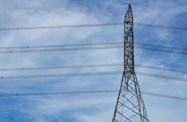 High voltage electricity poles and blue sky as the background