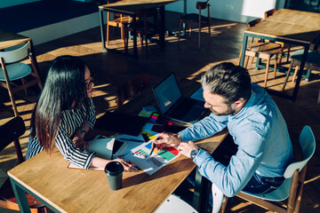 Entrepreneurs talking about project in workspace