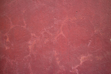 Old red textured wall, with cracks and stripes. Beautiful abstract background. High quality photo
