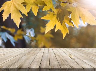Naklejka na ściany i meble Wooden desk on autumn blur abstract natural background