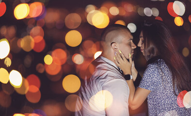 Lovers man and girl against background night city, sky and horizon. Concept date Valentine Day, first kiss love