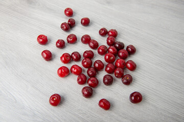 ripe cherry scattered on a light wooden table