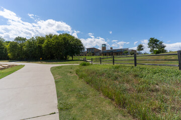 A concrete path in a Texas city park on a sunny August day.