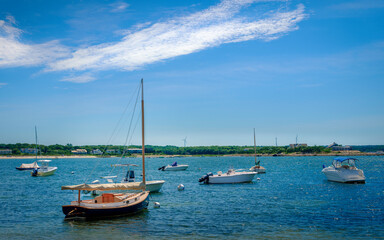 Fototapeta na wymiar Seascape with moored boats at bay on blue sky with white clouds backgrounds