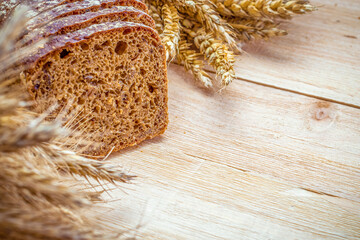Freshly baked bread. Fresh loaf of rustic traditional bread with wheat grain ear or spike plant on...
