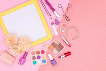 Make up products and photo frame on pink theme 