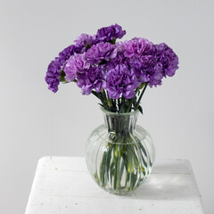 Bridal bouquets of lilac carnations in a four round glass vases different sizes as table decoration © elenarostunova