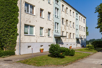 Fototapeta na wymiar Old east German apartment building with worn paint.