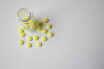 Yellow Valerian pills on white background