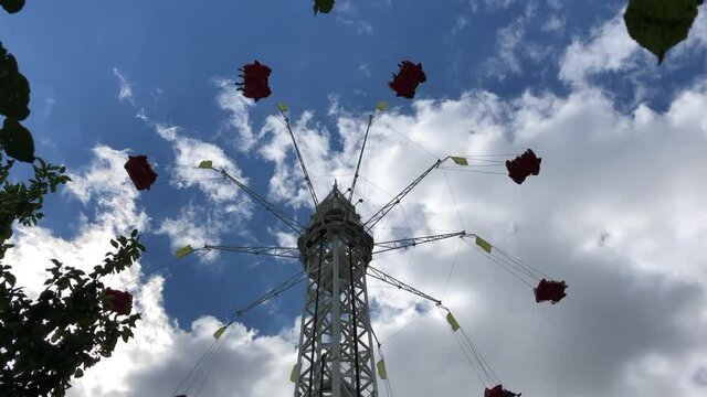 the ride is spinning at the top of the outdoor amusement Park