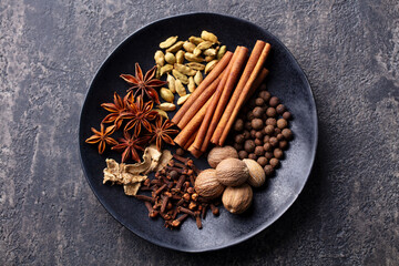 Spices for Indian masala chai. Grey background. Close up. Top view.
