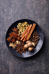 Spices for Indian masala chai. Grey background. Top view.
