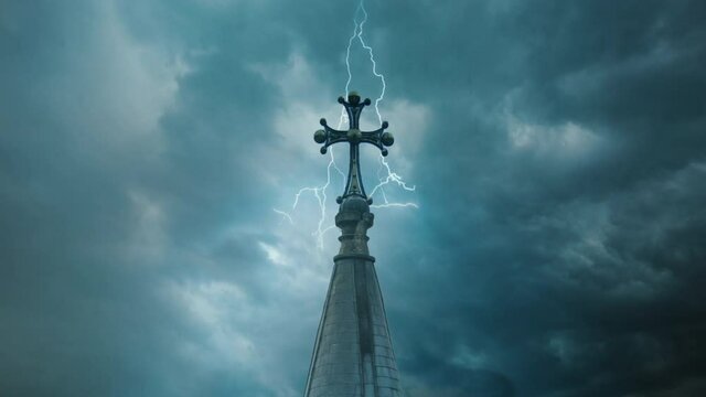 Rain clouds with lightning passing over the church tower