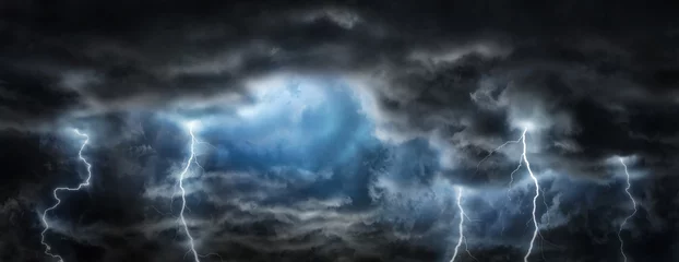 Raamstickers Sun rays, clouds and sparkling lightning in the dark sky. Thunderous dark sky with black clouds. Concept on the theme of weather, natural disasters, storm,  thunderstorms,, lightning. © Tryfonov