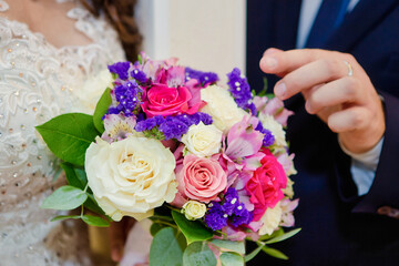 The bride's bouquet is close-up. White and pink roses.