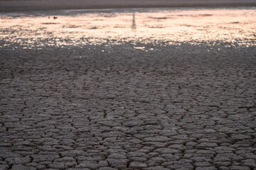 dry bottom of the reservoir. soil erosion. the water's gone. the bottom of the lake. a desert...