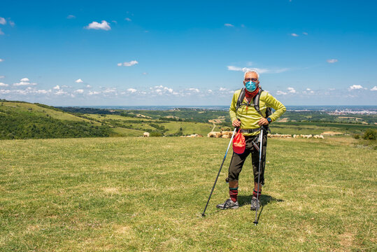 Active Caucasian Senior Man Wearing Medical Face Mask While Hiking In High Mountains 